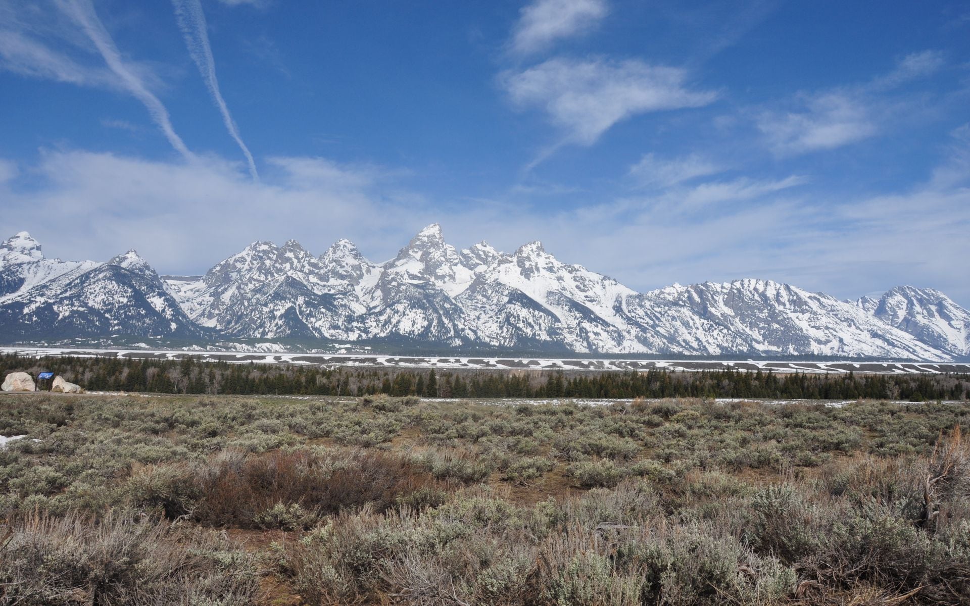 Wyoming Highway 191 crossing sagebrush flats south of Jackson with the Teton Range in the background